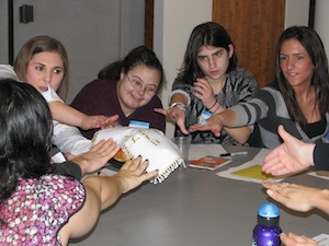Participants at Tufts Hillel practice saying the motzi