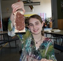 Olivia enjoys a matzah snack