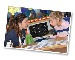 Mira and Adina use visual supports to say Shabbat blessing over candles